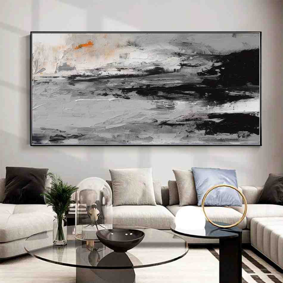 A modern art piece placed above the light grey sofa on wall