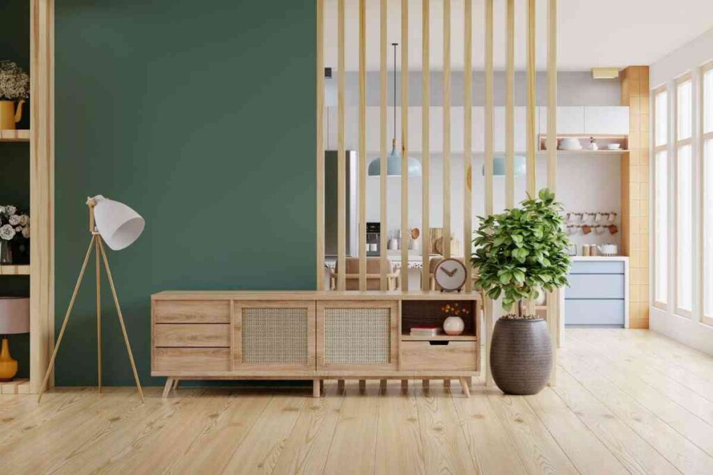 Green wall with wooden pillars and a wooden bench for the separation