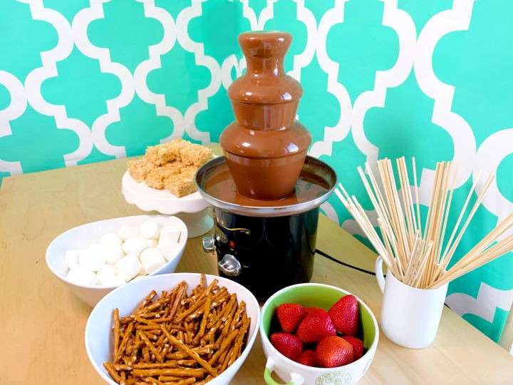 chocolate fondue fountain with strawberries and sticks