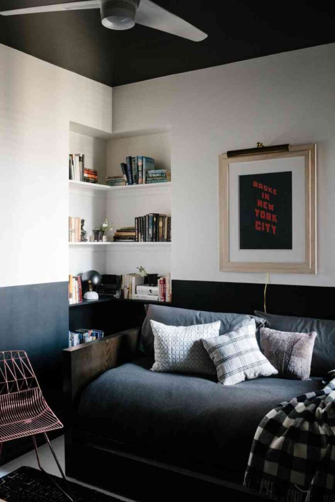 Two tone wall and a gray sofa in front of it