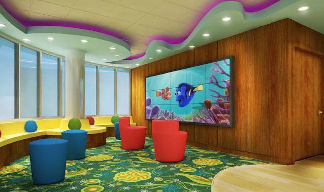 A big screen playing cartoon movie and seating area for kids with colorful seats
