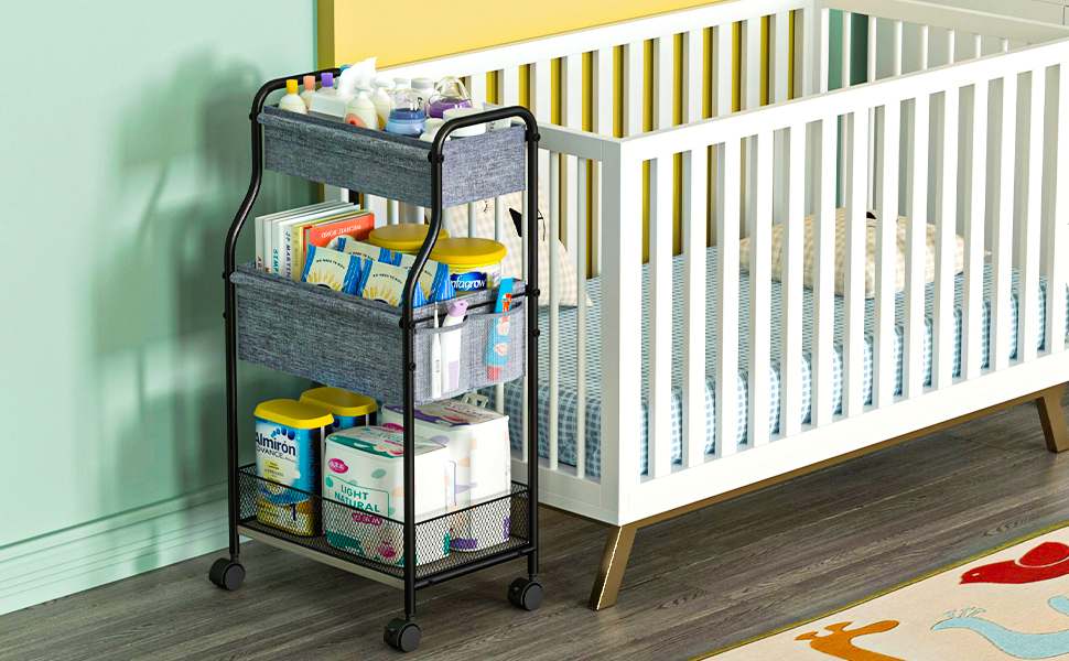 A black and gray color rolling cart and a white crib beside it