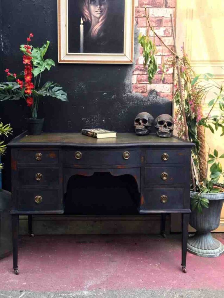 A black ventage wooden writing desk for the gothic theme