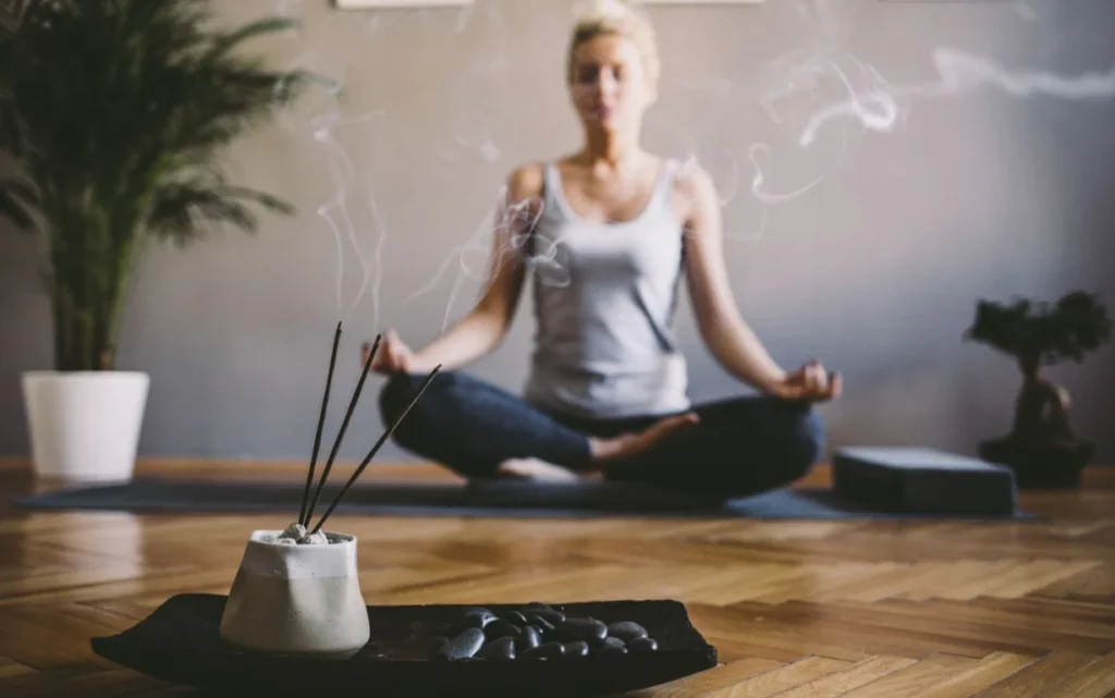 A girl doing meditating in the room