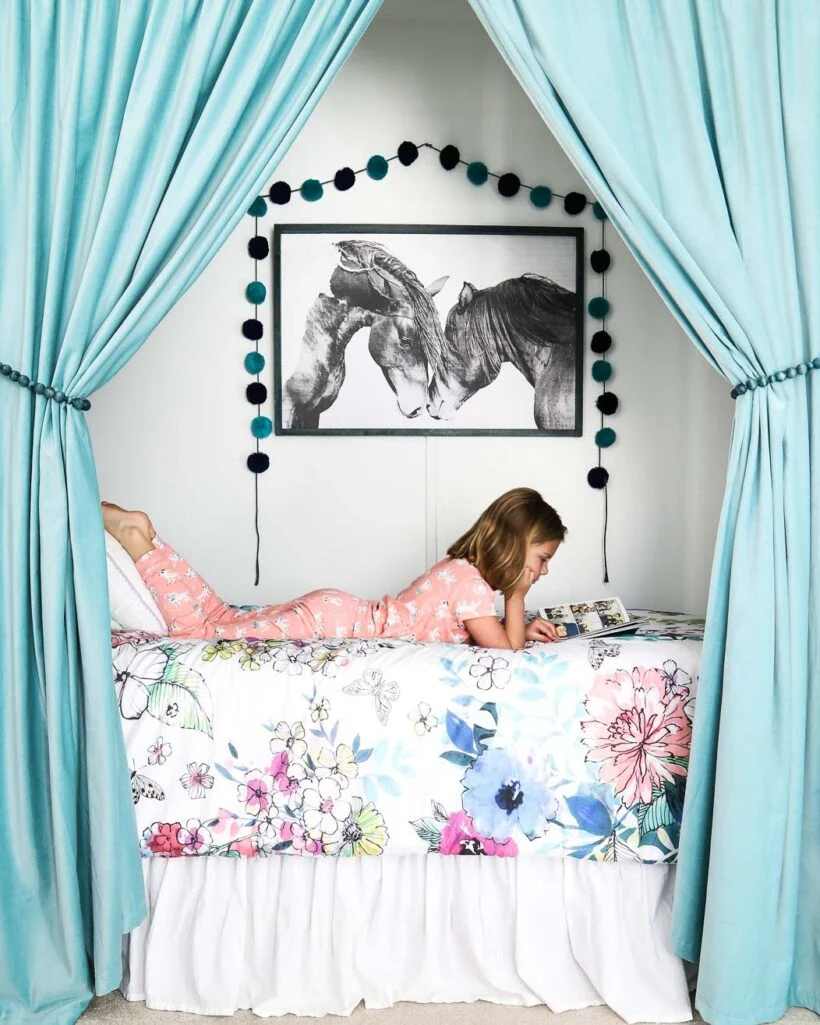 A girl reading a book on bed and a canopy on edgesv