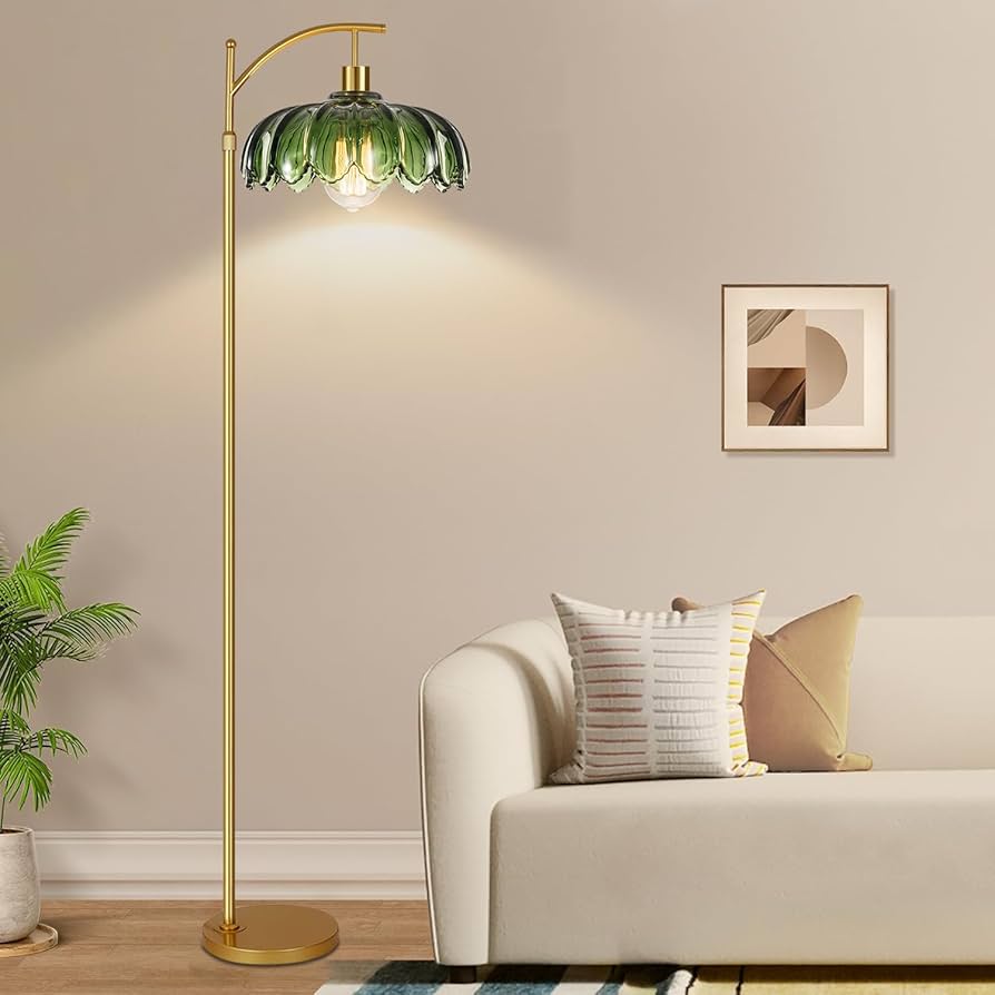A golden frame light with green top and a white sofa