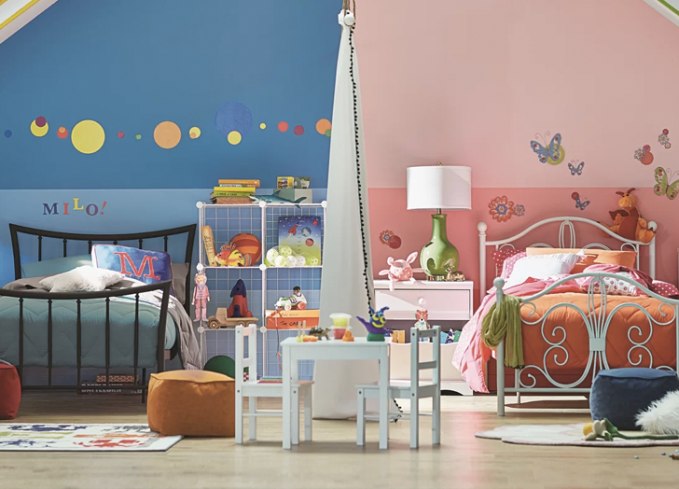 A room with two wall color and decals for the shared bedroom and wall murals in different theme
