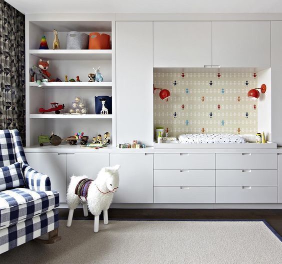 A sheep soft toy and white built-in storage cabinet for the toys and babies cloth