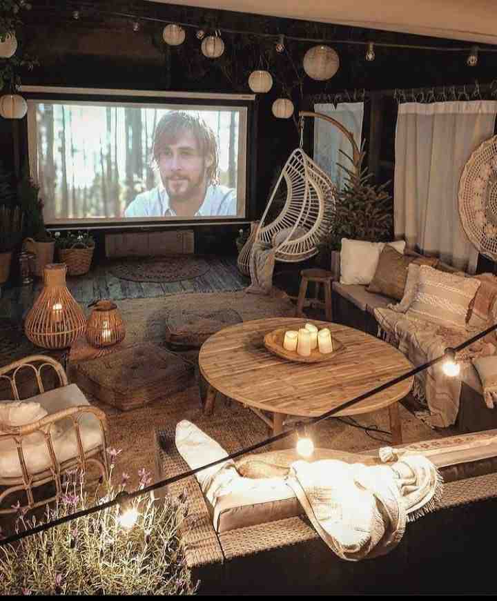 Fairy bulb lights and a wooden center table for the movie set up in she room 