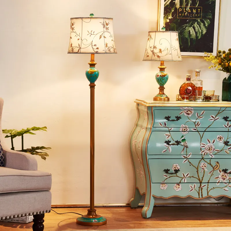 A blue color side cabinet and a floor lamp with floral prints on it