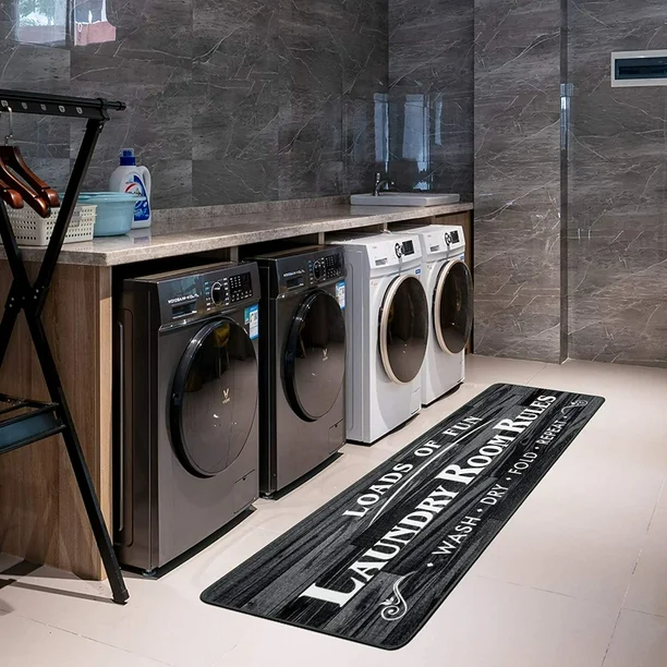 Black and white rug on floor in laundry room with four washing machine 
