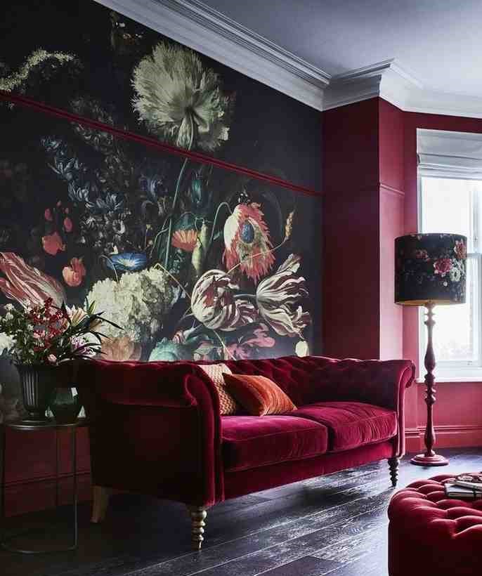 Velvet burgundy sofa and a black floral wallpaper