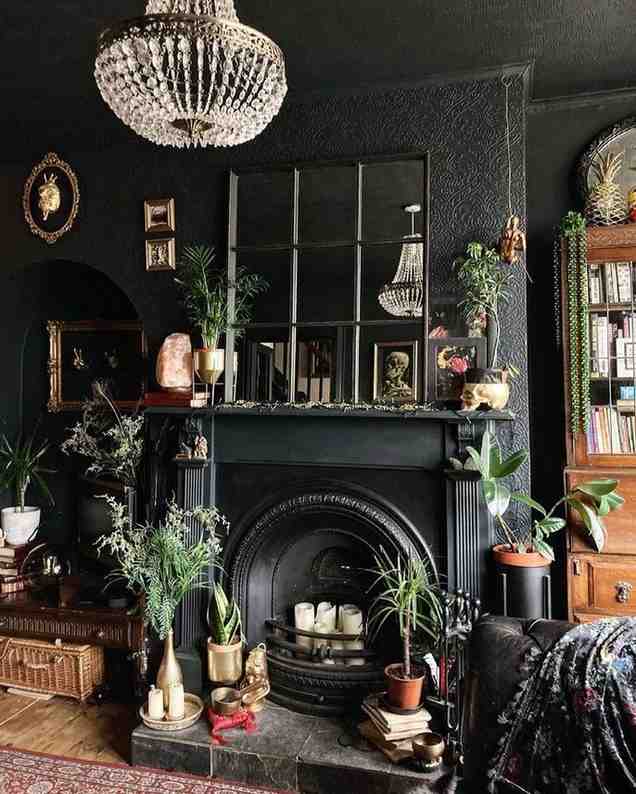 Black colored fireplace and mini plants and candle on it