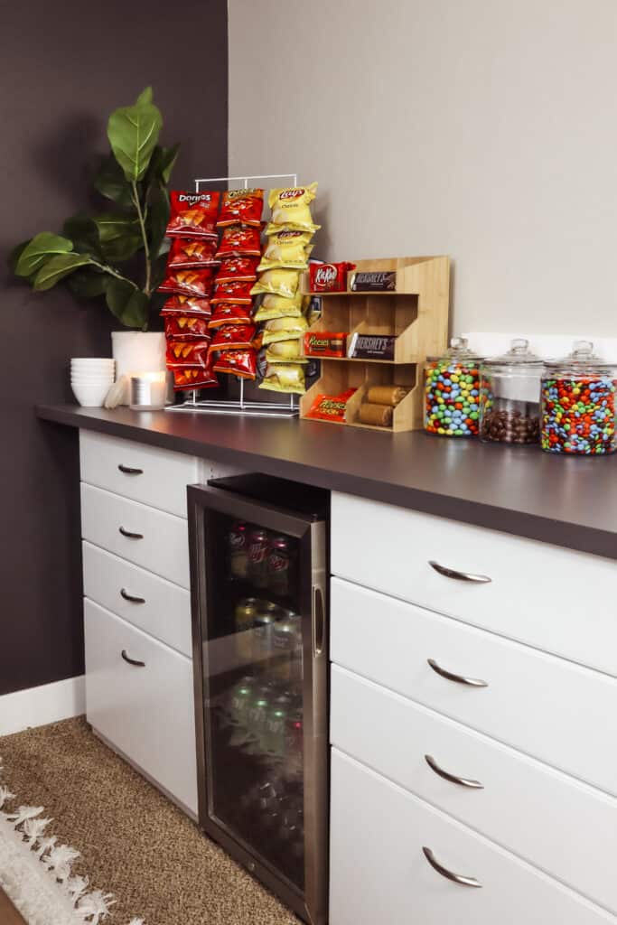 Brown and white cabinet and snack on it with a plant