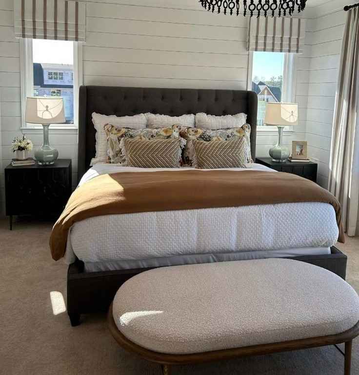 Boho pillow and a brown color blanket and white color bedsheet