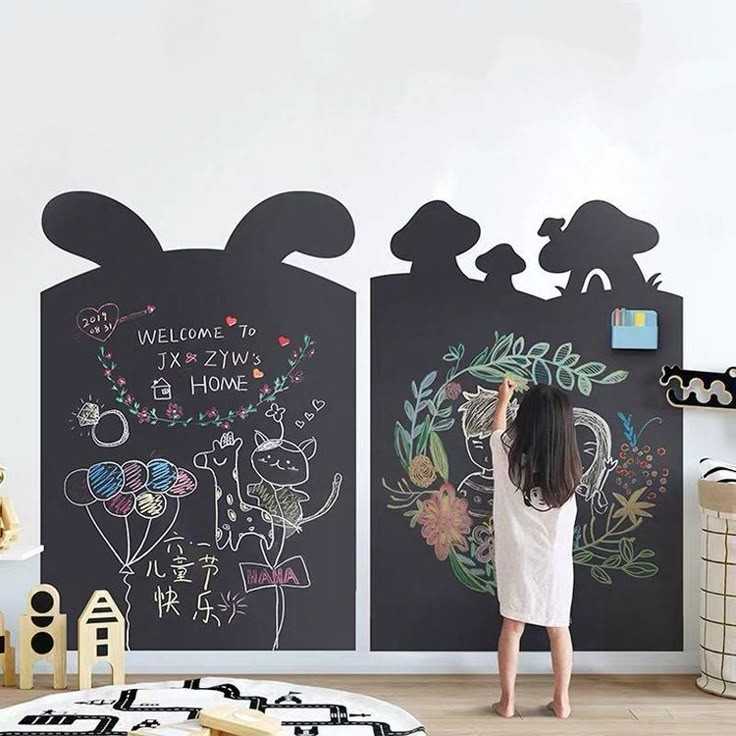 Chalkboard paste on wallpaper in different shapes and a baby drawing on it