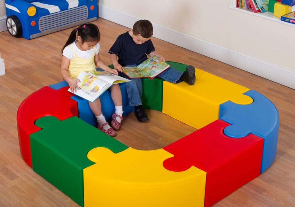 Colorful block seating area and kids seating on it in room