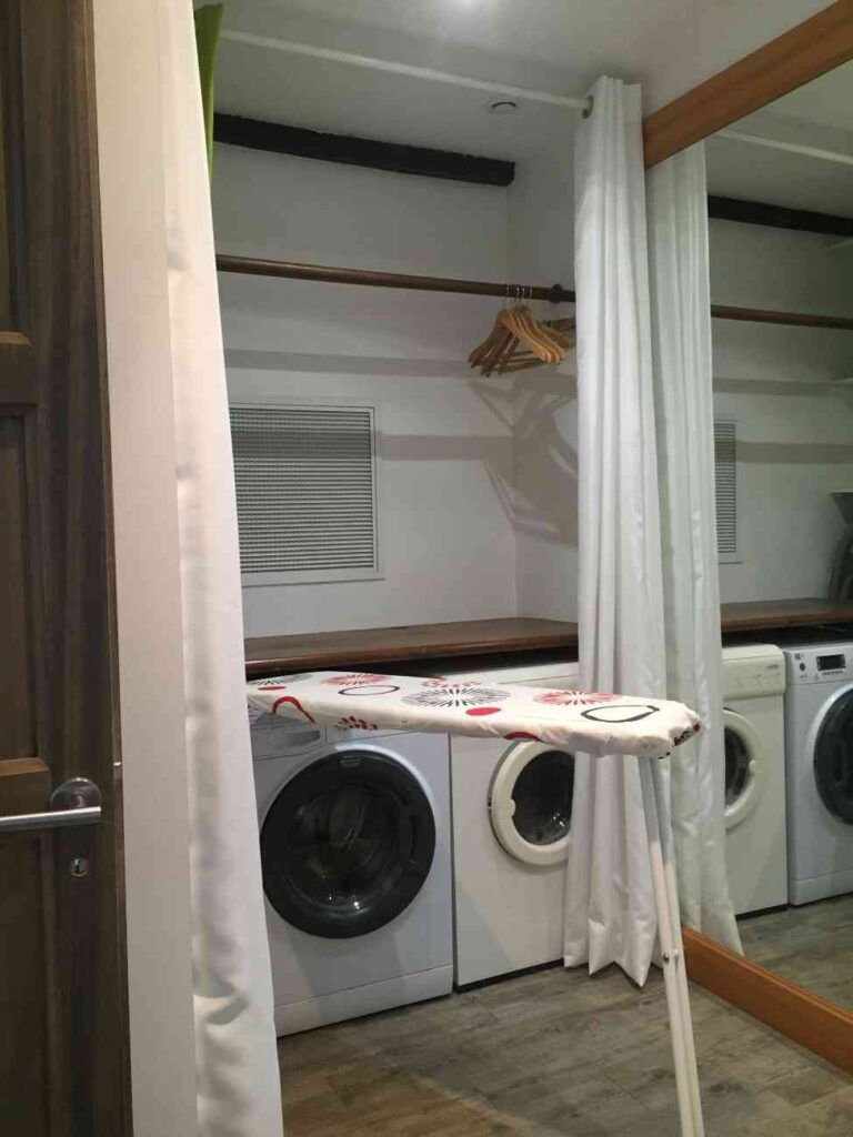 An ironing nook covered with curtain