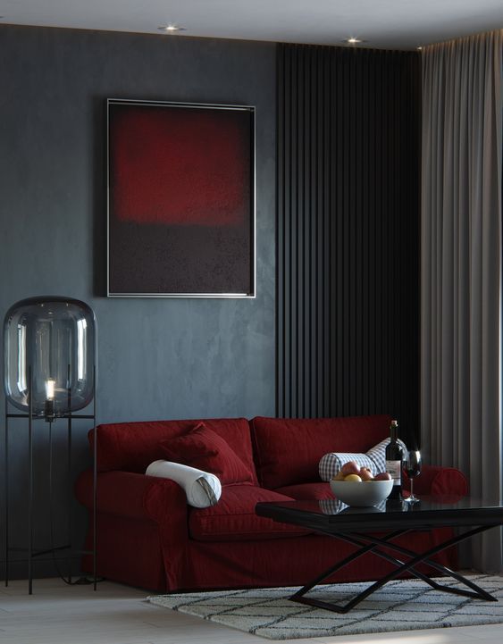 Dark blue color wall and burgundy sofa against it and a burgundy color painting above it