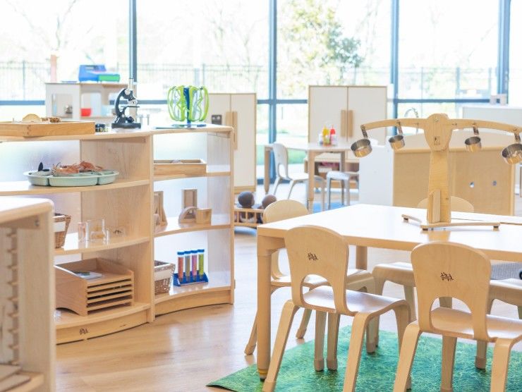 Wooden furniture for kids and floor to ceiling windows in room for the kids