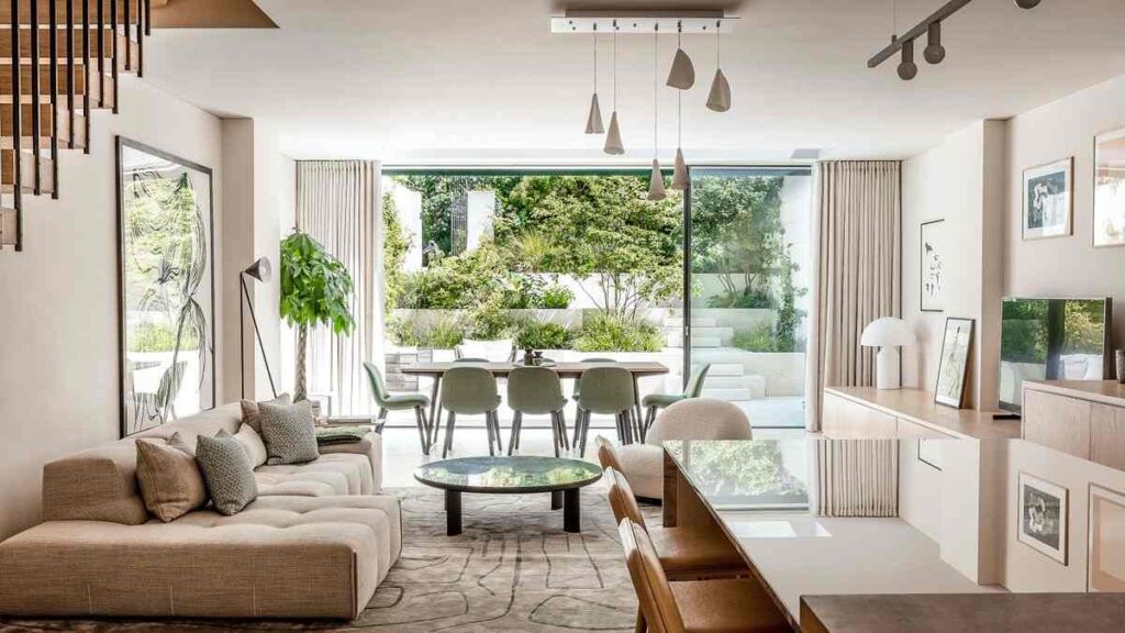 Floor to ceiling windows in room and a dining table with a sofa