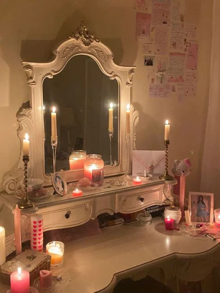 Glass and metal made candle holder on dressing table with candles