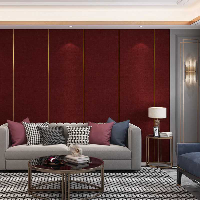 A grey sofa and a burgundy and golden wall panelling behind it