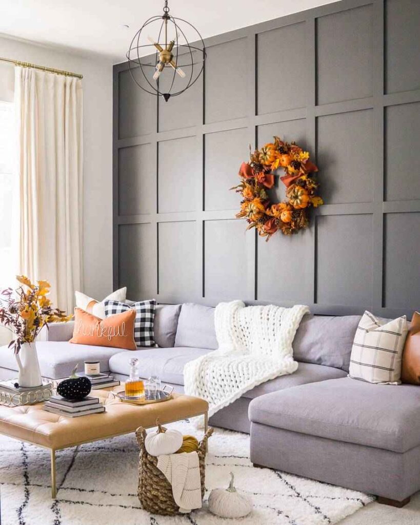 Gray color board and batten wall panelling and  sofa with a leather coffee table