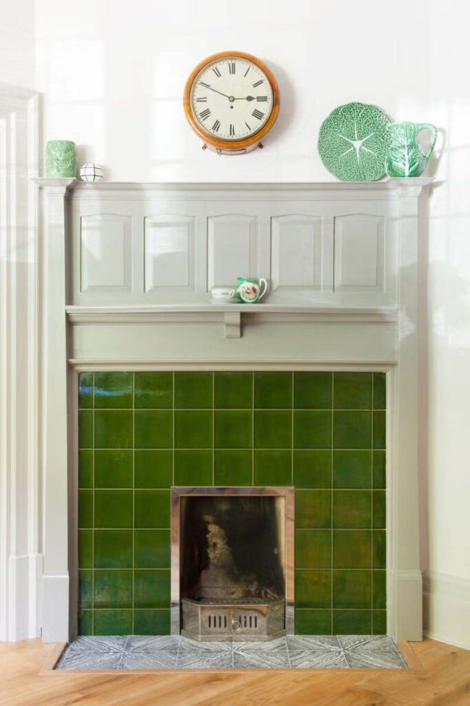 Green brick and golden line fireplace with white wall