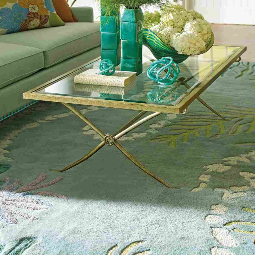Green muse rug and golden frame table with glass top