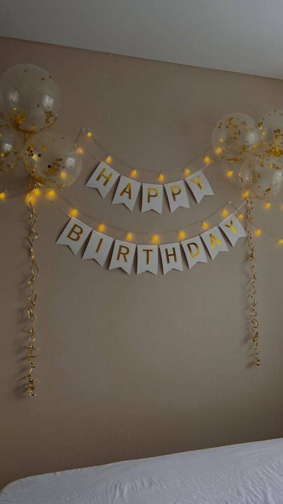 Golden and white color happy birthday banner with balloon decoration 