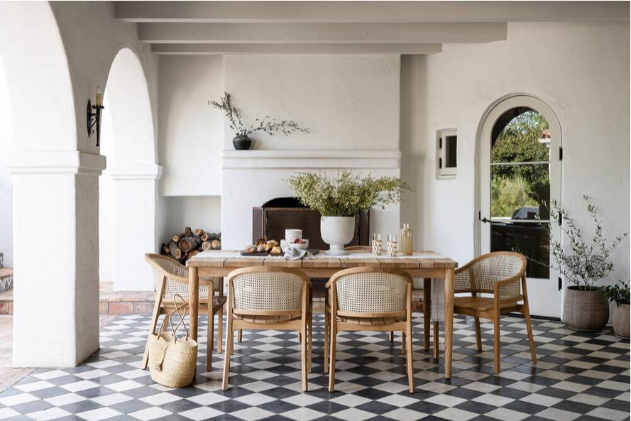 Jute and wooden chair and some plants and black and white checkerboard flooring