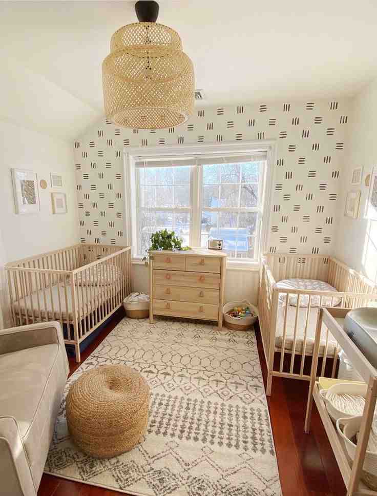 Jute ceiling lamp and black and white accent wall and a rug with a wooden crib for the room