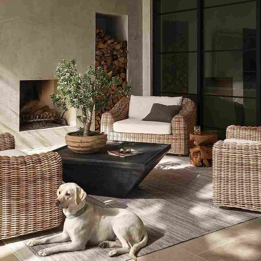 A black wooden table and jute chair and a dog laying on a rug