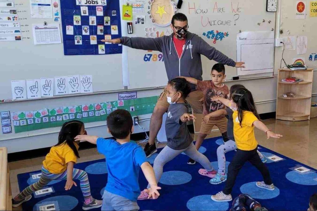 Kids doing exercise on a blue mat