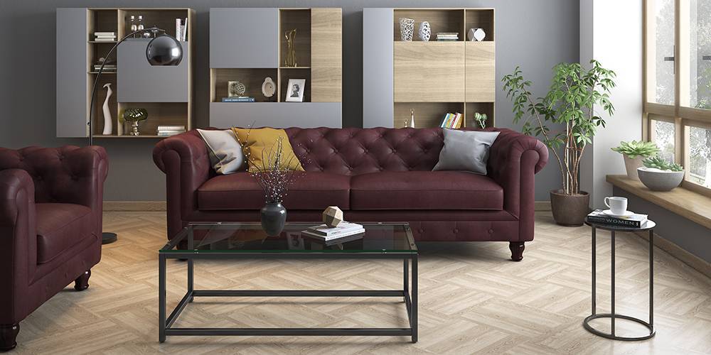 Blue built-in cabinet and a black glass top table and a burgundy sofa