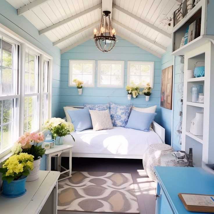 Light blue wall and a white seating with some pillow on it for the coastal theme room