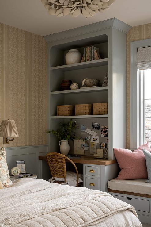 Mint green color built-in cabinet for storage with a chair and golden color wallpaper