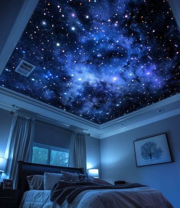 Starry light ceiling in blue color and a art frame on wall with a bed 