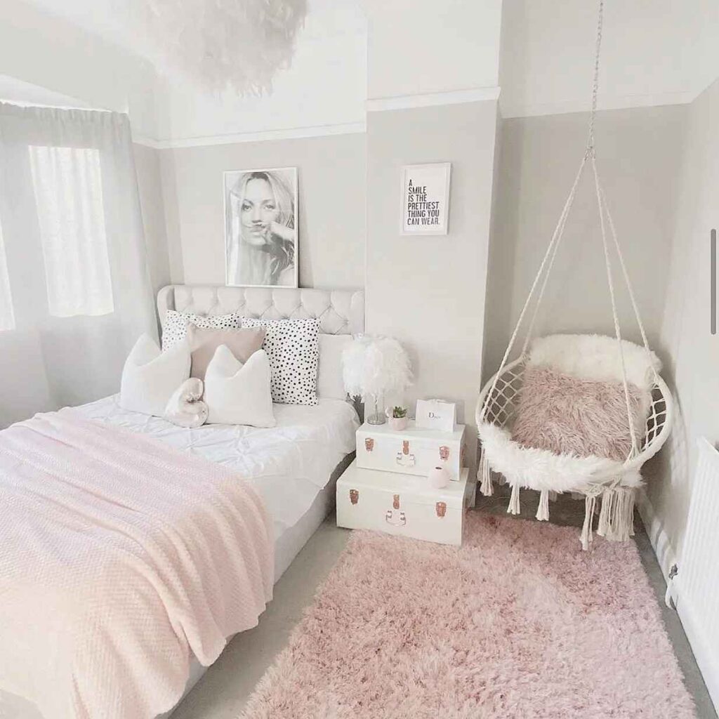Pink and white color hammock hanging chair and a bed with a painting above it