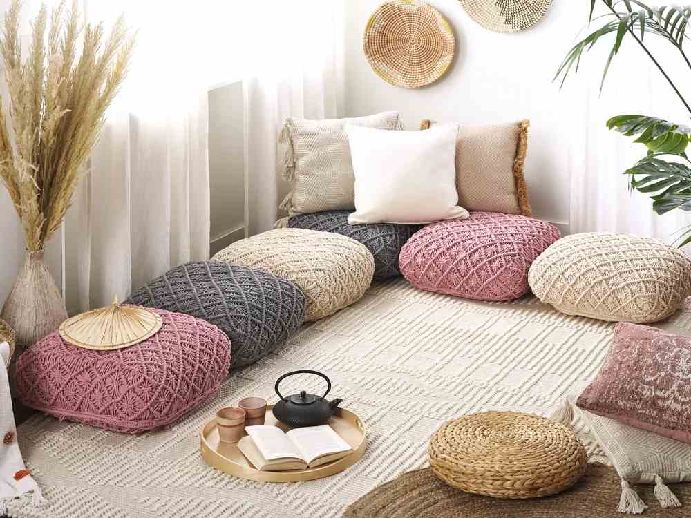 Multicolor floor cushions and a wooden tray at side