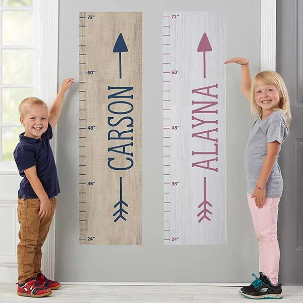 Two different growth chart on wall and kids standing