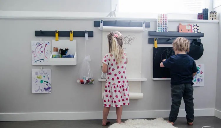 Black and white wall mounted coloring sheets and kids drawing on it