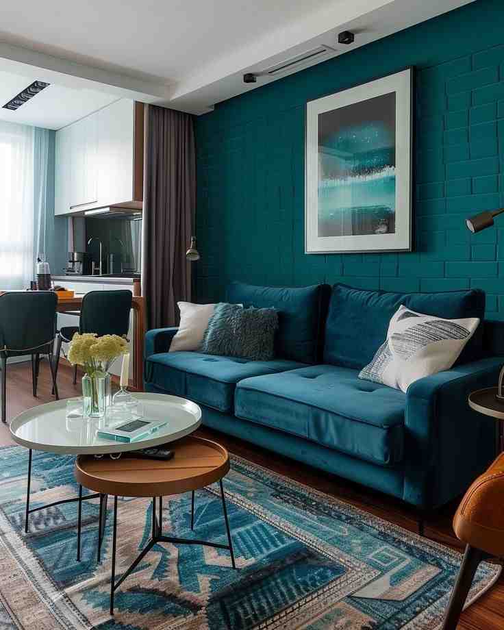 Two layer coffee table with rug and a dark teal sofa with dark wall painting for the living room