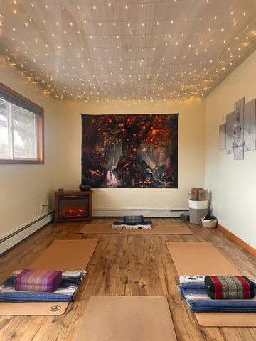Vertical space Yoga room and two mats on floor with a tapestry hanging on wall