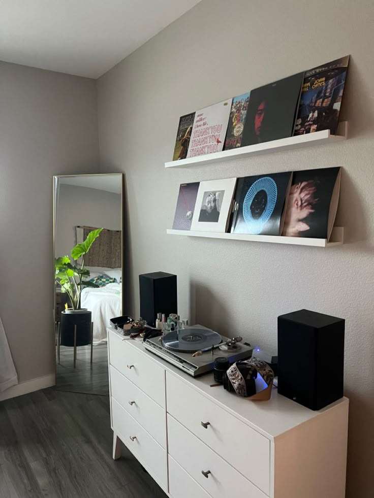 A white cabinet and floating shelve for the vinyl record display 