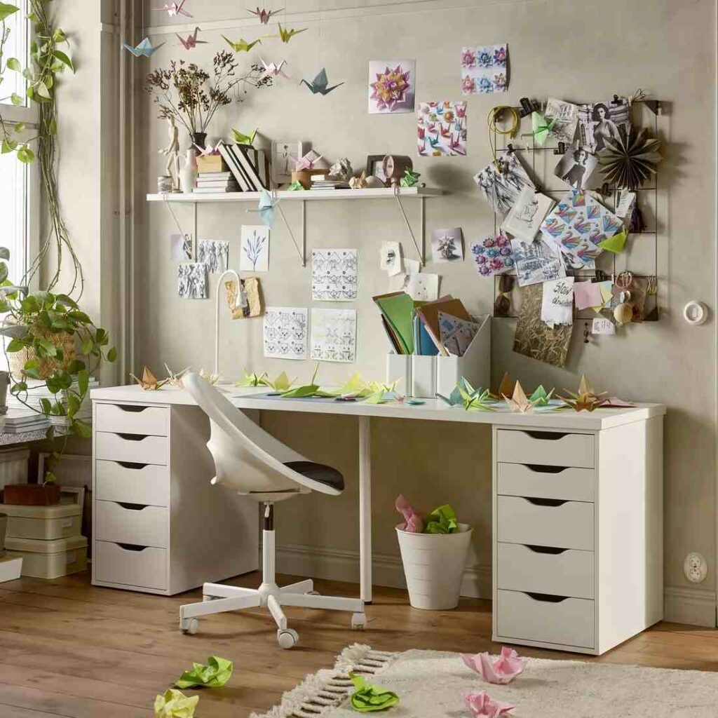 White Alex table with drawer and a chair with notes on wall