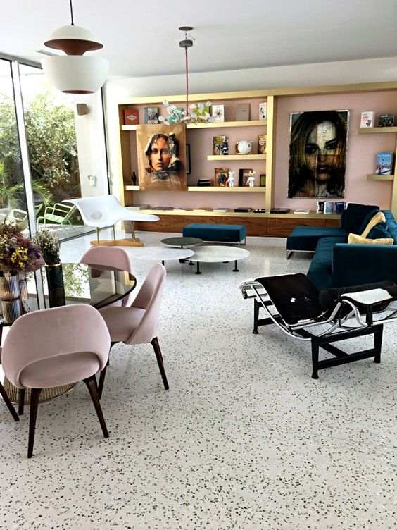 White and black dots terrazzo flooring and pink velvet chair with a glass top table