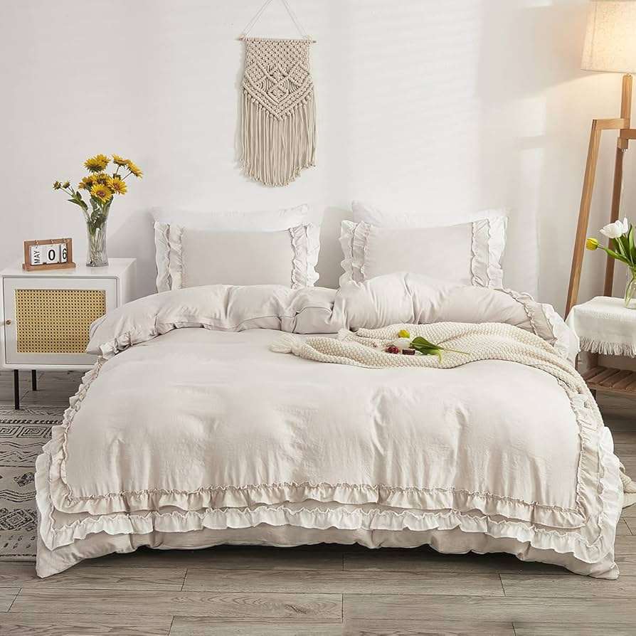 White and cream color ruffled bedsheet with pillows