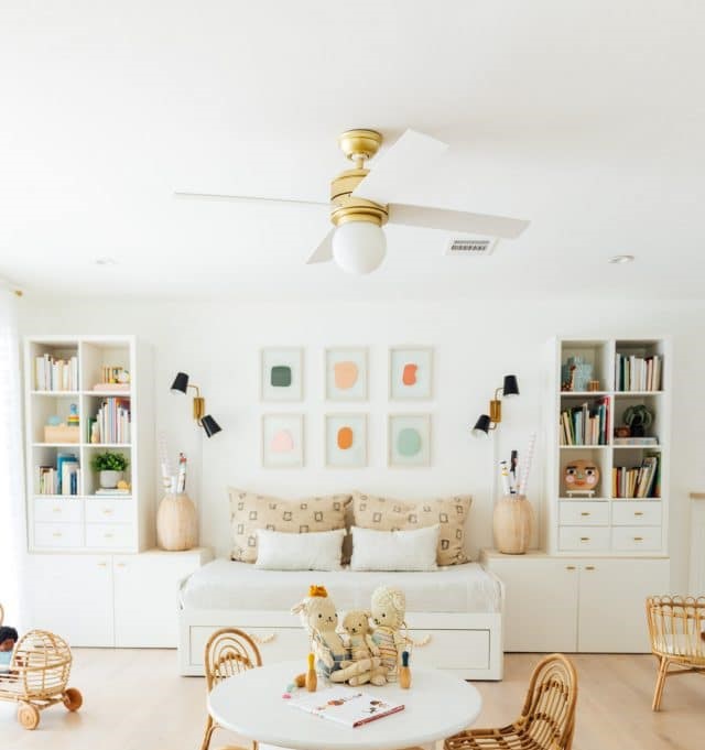 White built-in cabinet and a bench between it and wooden table and chair